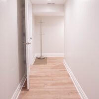 Thumbnail of http://Hallway%20with%20coat%20rack%20and%20an%20open%20door.