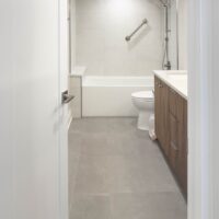 Thumbnail of http://Bathroom%20looking%20past%20the%20sinks%20and%20toilet%20to%20the%20shower%20and%20tub%20combination.