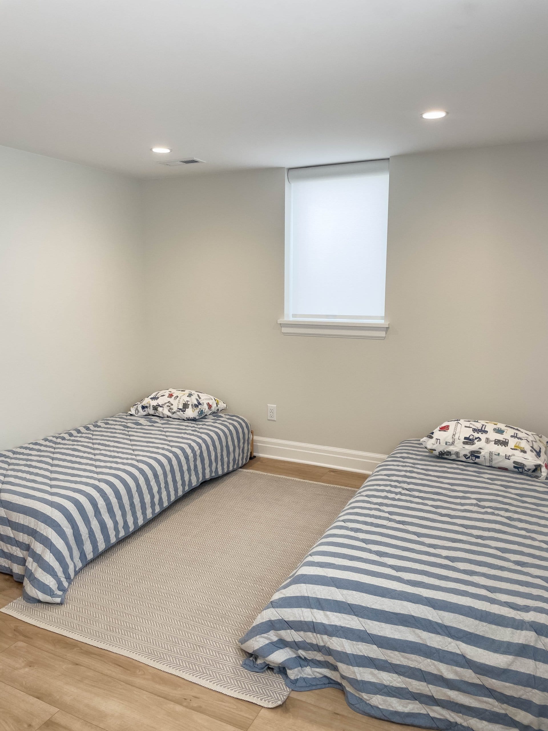 Bedroom with two beds and a window.