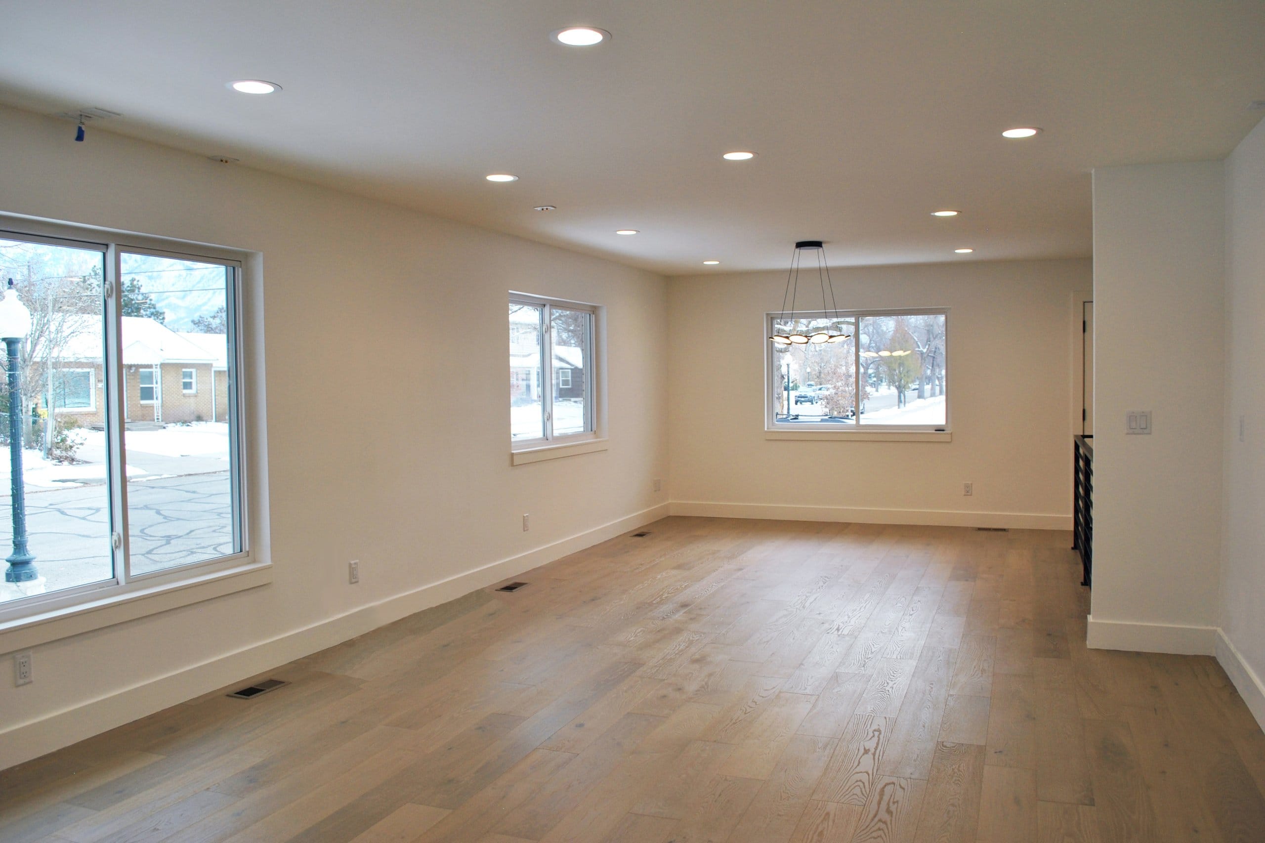 Open concept living room and dining room with no furniture.