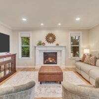 Thumbnail of http://Family%20room%20fireplace%20with%20windows%20on%20either%20side%20and%20seating%20in%20front.