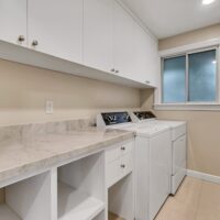 Thumbnail of http://Laundry%20room%20with%20white%20cabinetry%20and%20appliances.