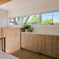 Thumbnail of http://Built-in%20cabinets%20in%20the%20laundry%20room%20that%20extend%20down%20the%20stairs%20to%20in%20the%20mudroom.%20Above%20the%20cabinets%20are%20windows.