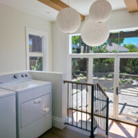 Thumbnail of http://The%20laundry%20room%20section%20of%20the%20addition%20is%20located%20between%20the%20kitchen%20and%20mudroom.%20The%20space%20features%20lots%20of%20natural%20light,%20wood%20beams%20on%20the%20ceiling,%20and%20three%20round%20light%20fixtures.