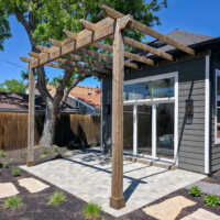 Thumbnail of http://Exterior%20of%20the%20addition%20featuring%20the%20large%20windows%20and%20patio%20with%20a%20pergola.