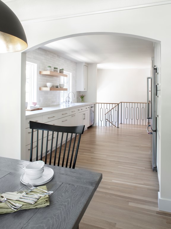 View from the dining room to the kitchen through an arch opening.