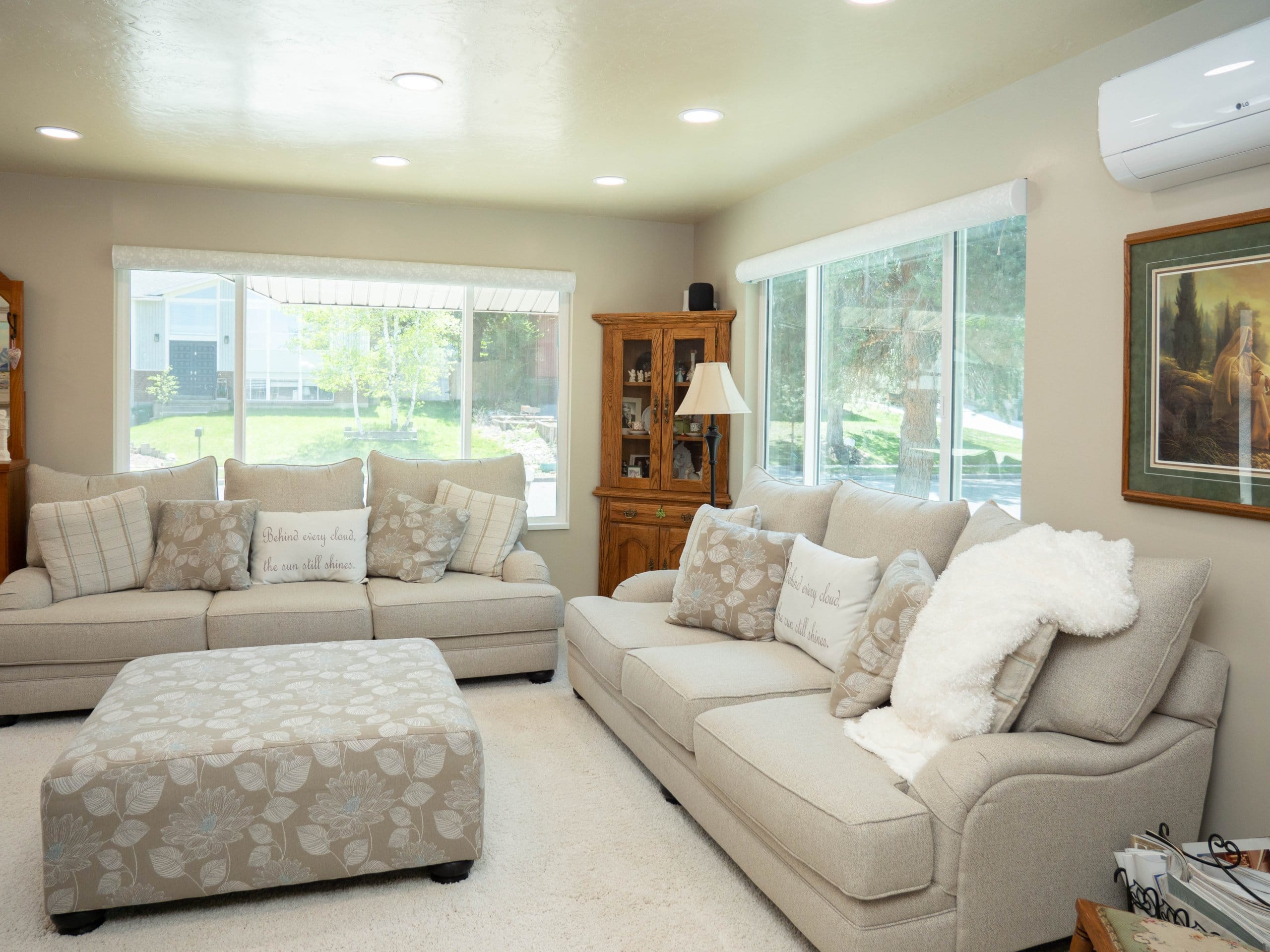 Family room remodel with the two couches under the windows and a bookcase in the corner between.