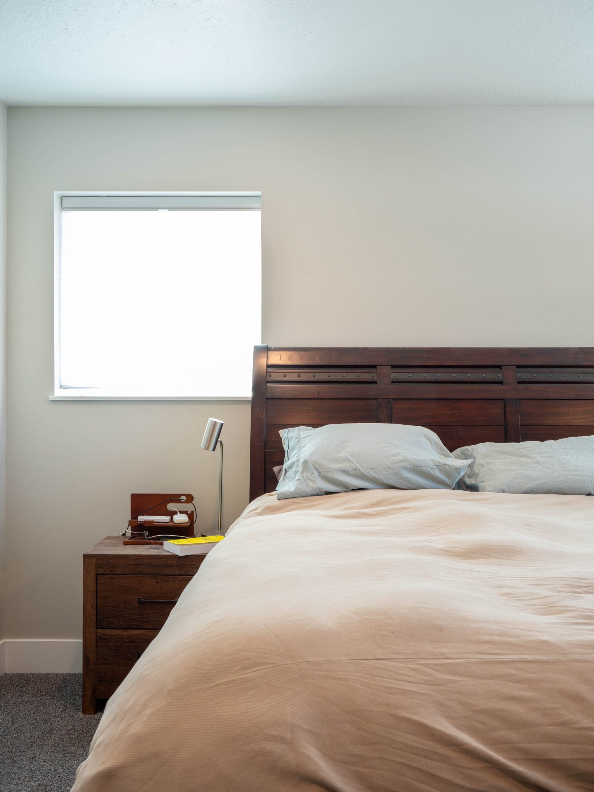 Bedroom with a bed and nightstand under the window.