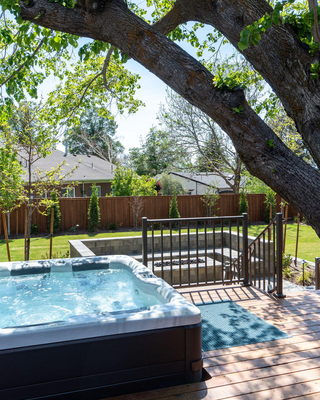 Hot tub on a deck overlooking the backyard,
