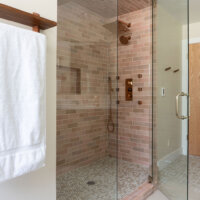 Thumbnail of http://Primary%20bathroom%20shower%20with%20a%20glass%20door.