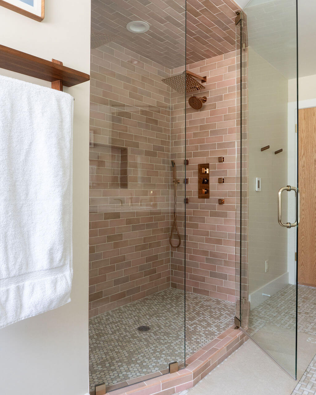 Primary bathroom shower with a glass door.