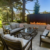 Thumbnail of http://Outdoor%20fireplace%20with%20two%20couches,%20chairs,%20and%20a%20coffee%20table%20in%20front.