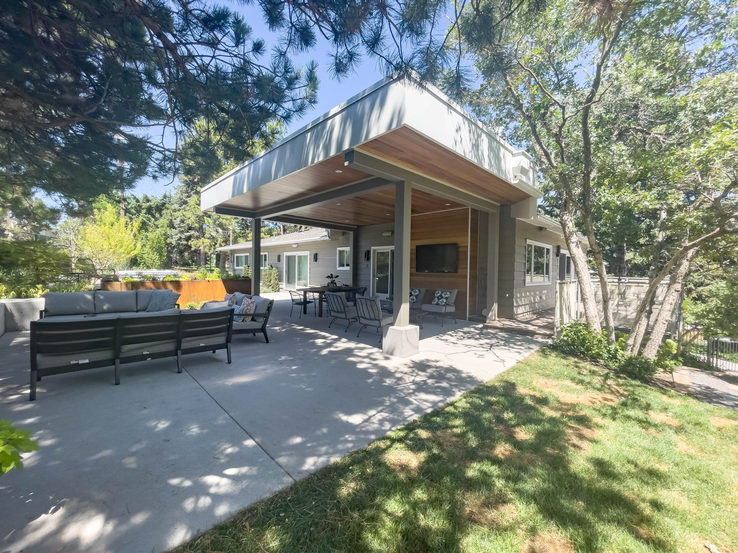 Covered patio and uncovered patio with outdoor furniture.