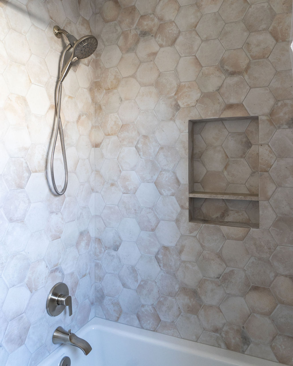 Updated bathroom shower with niche in the wall