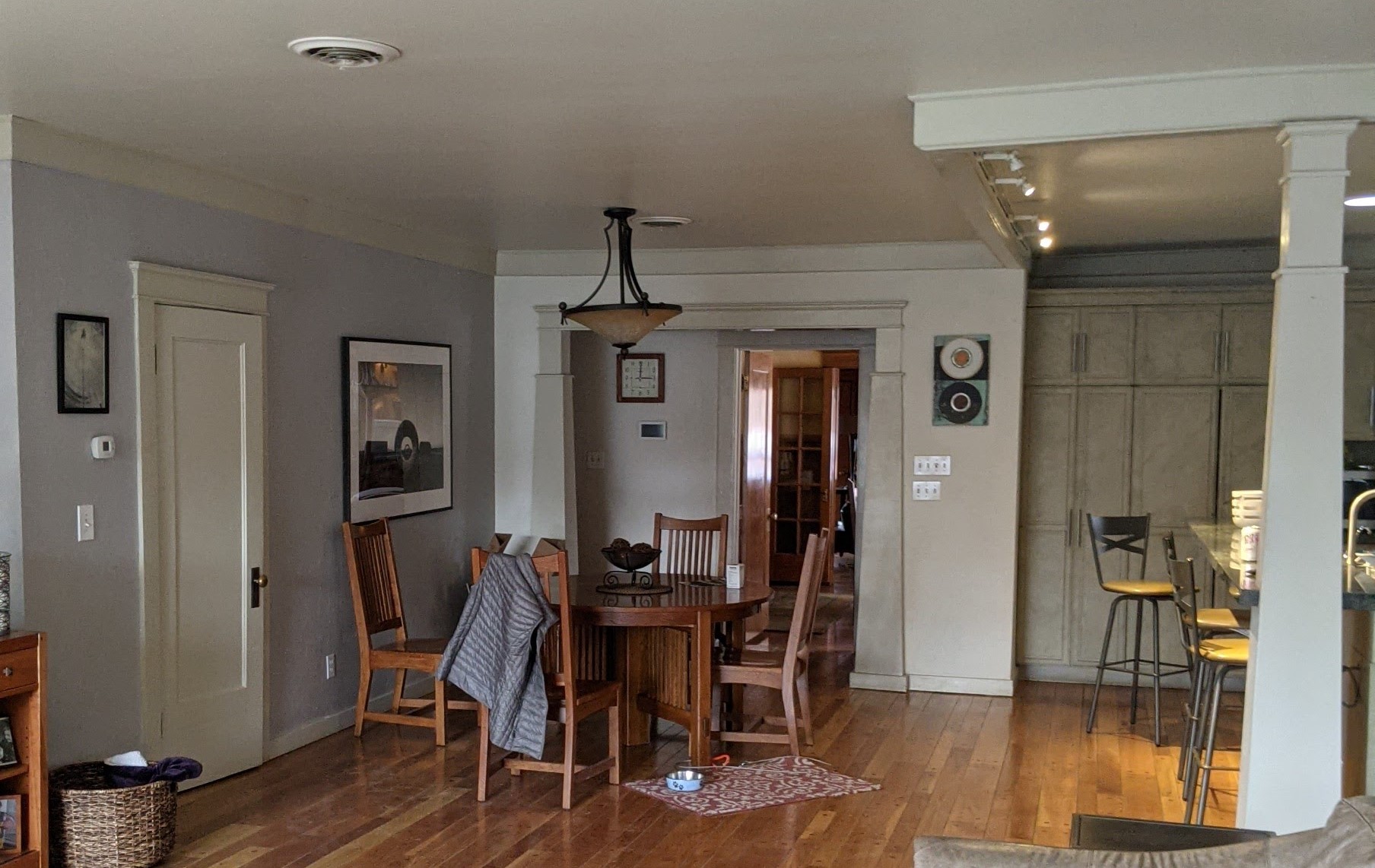 Before the remodel showing the dining room with the kitchen to the right, and the wall that divided the space with the formal dining room.