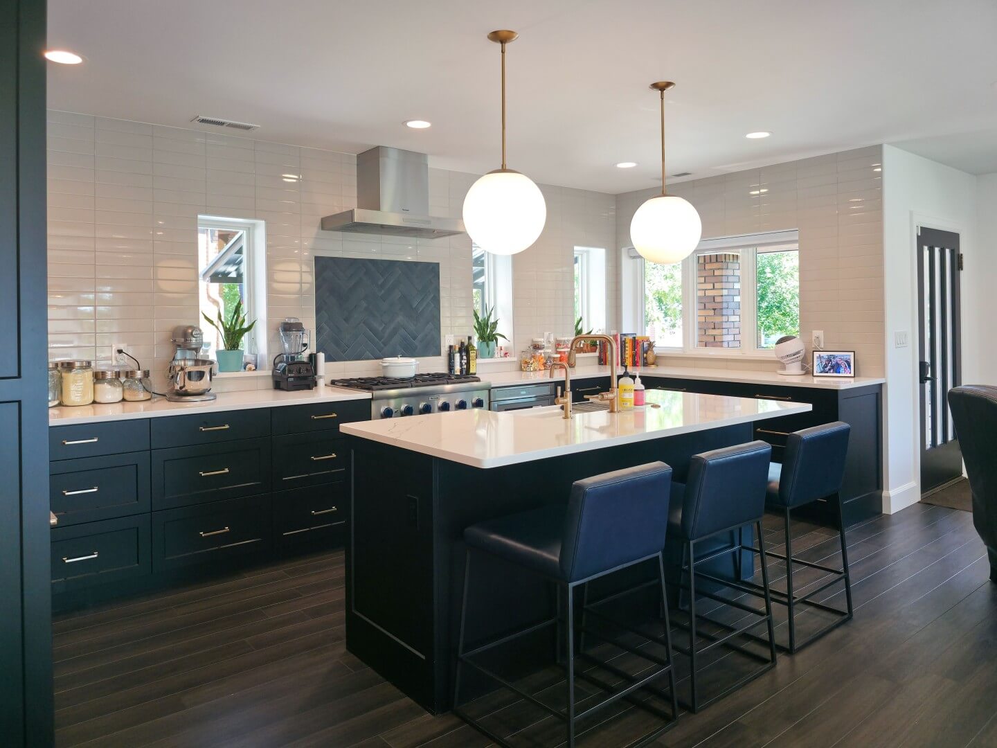 Open concept kitchen in a u-shaped layout. In the center is a large island with seating.