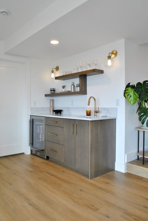 Small wet-bar in the basement with a mini-fridge and sink.