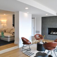 Thumbnail of http://Sitting%20area%20in%20front%20of%20the%20fireplace.%20Four%20chairs%20are%20placed%20around%20a%20coffee%20table%20and%20on%20a%20round%20rug.