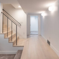 Thumbnail of http://Hallway%20in%20the%20basement%20that%20leads%20to%20a%20bedroom,%20bathroom,%20stairs,%20and%20the%20sunken%20family%20room.