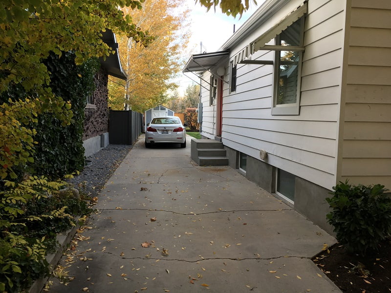The driveway before the garage with a parked car.
