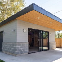 Thumbnail of http://Modern%20garage%20building%20that%20doubles%20as%20entertaining%20space%20with%20a%20sliding%20door%20that%20opens%20to%20the%20covered%20patio.