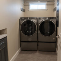 Thumbnail of http://Side-by-side%20washer%20and%20dryer%20with%20a%20small%20window%20and%20rod%20to%20hang%20clothes%20on%20above.