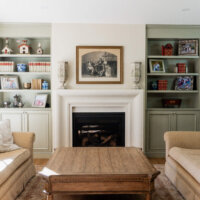 Thumbnail of http://Living%20room%20fireplace%20with%20a%20picture%20hung%20above%20and%20bookshelves%20built-in%20on%20either%20side.