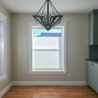 Thumbnail of http://Updated%20dining%20room%20with%20the%20kitchen%20to%20the%20right,%20a%20light%20hanging%20from%20the%20ceiling%20in%20the%20center,%20and%20two%20windows.