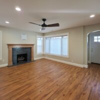 Thumbnail of http://Renovated%20living%20room%20with%20a%20ceiling%20fan,%20updated%20fireplace,%20wood%20flooring,%20and%20multiple%20windows.