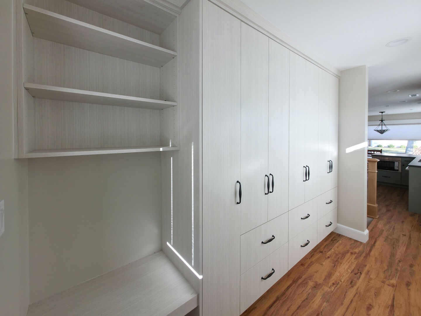 Cabinetry in the new mudroom that includes a built-in bench, shelves, cabinets, and drawers.