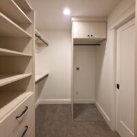 Thumbnail of http://Large%20walk-in%20closet%20with%20lots%20of%20shelving%20and%20a%20place%20for%20a%20stackable%20washer%20and%20dryer.%20On%20the%20right%20the%20pocket%20door%20with%20access%20to%20the%20bedroom%20is%20closed.