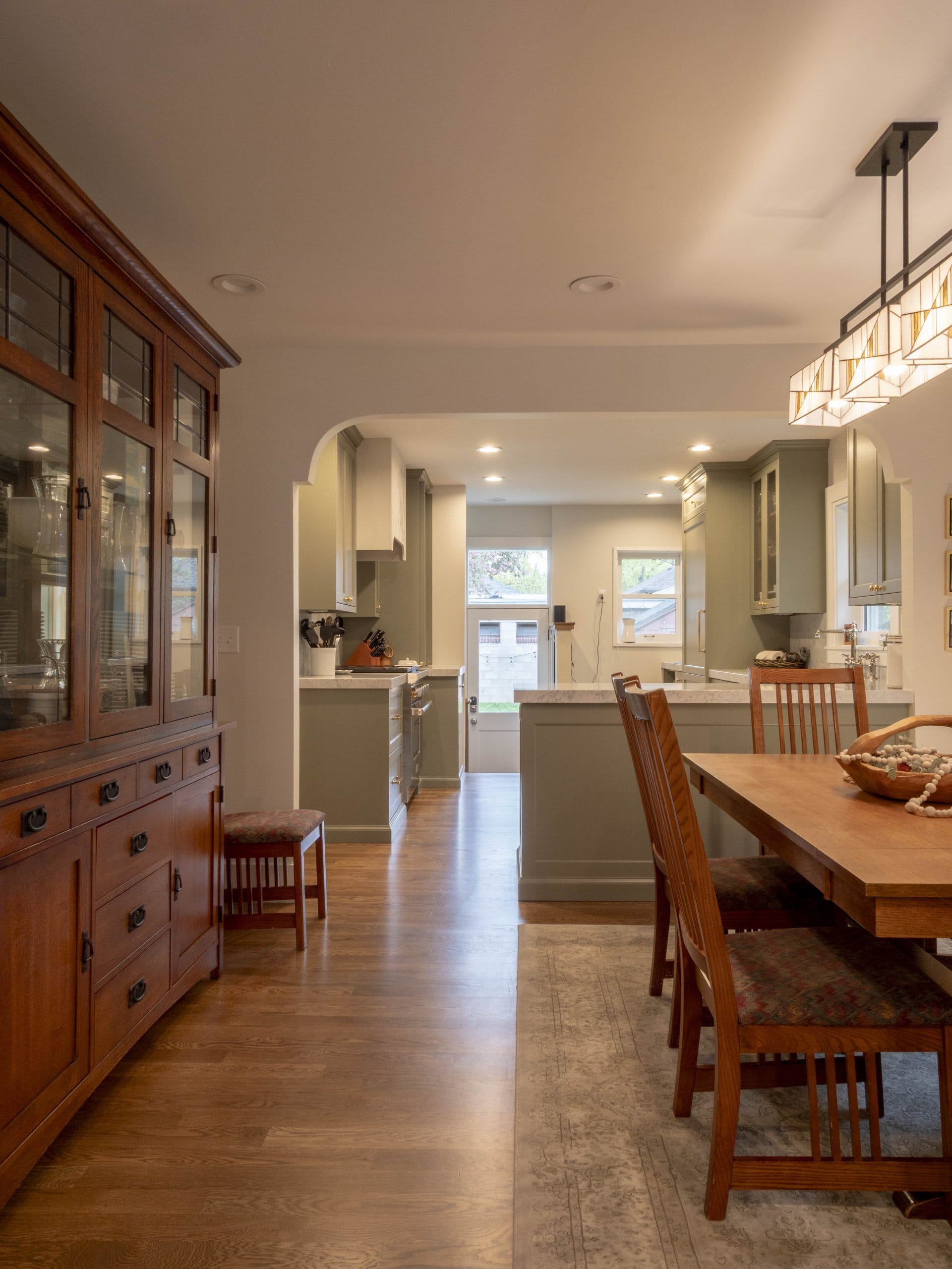Open concept dining room and kitchen looking all the way to the back door.