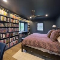 Thumbnail of http://Primary%20bedroom%20with%20built-in%20bookshelves%20and%20a%20ceiling%20fan.