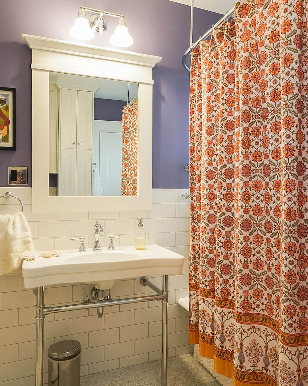 Renovated bathroom with a sink and tub. The tub is blocked by a shower curtain.