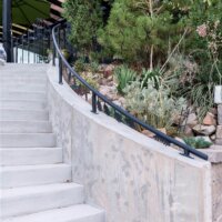 Thumbnail of http://Exterior%20staircase%20leading%20from%20the%20driveway%20up%20to%20the%20front%20door%20and%20new%20patio.%20The%20concrete%20stairs%20are%20slightly%20curved%20and%20include%20a%20metal%20railing.