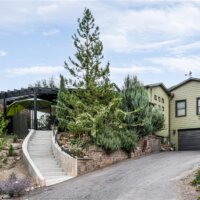 Thumbnail of http://Exterior%20of%20a%20home%20from%20street%20view.%20The%20street%20level%20includes%20a%20garage%20with%20stairs%20up%20to%20a%20patio%20and%20the%20front%20door.