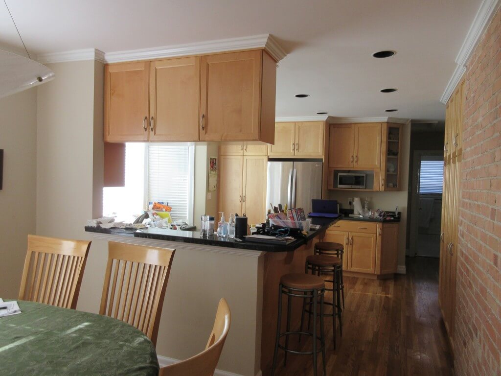 Kitchen before the remodel with cabinets between the kitchen and dining room.