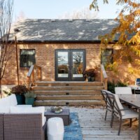 Thumbnail of http://Outdoor%20entertaining%20space%20on%20a%20fall%20day.%20The%20space%20includes%20outdoor%20furniture,%20a%20grill,%20plants,%20and%20stairs%20up%20to%20the%20house.
