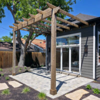Thumbnail of http://Exterior%20of%20the%20addition%20featuring%20the%20large%20windows%20and%20patio%20with%20a%20pergola.