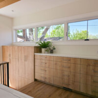 Thumbnail of http://Built-in%20cabinets%20in%20the%20laundry%20room%20that%20extend%20down%20the%20stairs%20to%20in%20the%20mudroom.%20Above%20the%20cabinets%20are%20windows.
