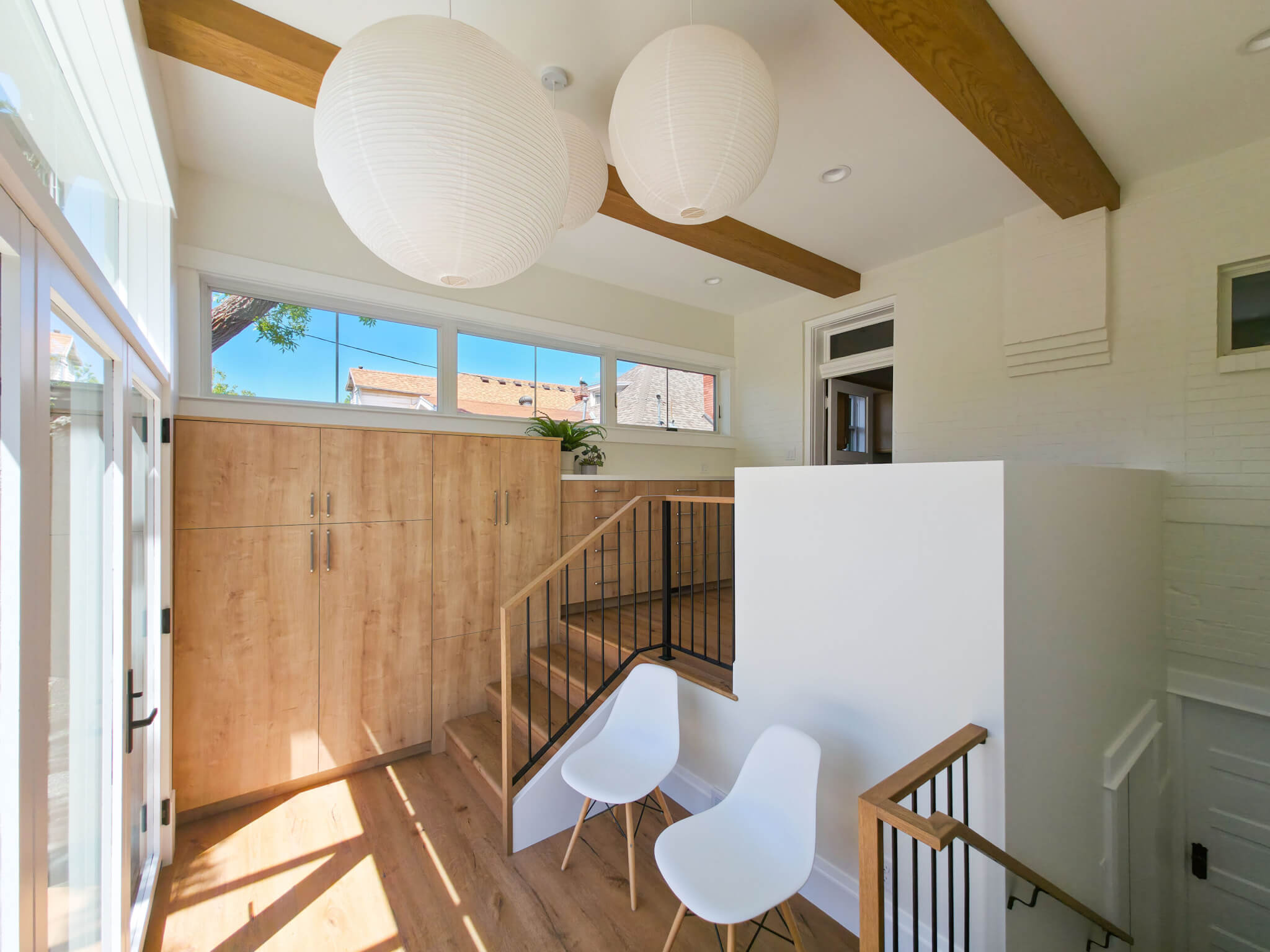 Mudroom addition with lots of natural light, built-in storage, and a small sitting area.