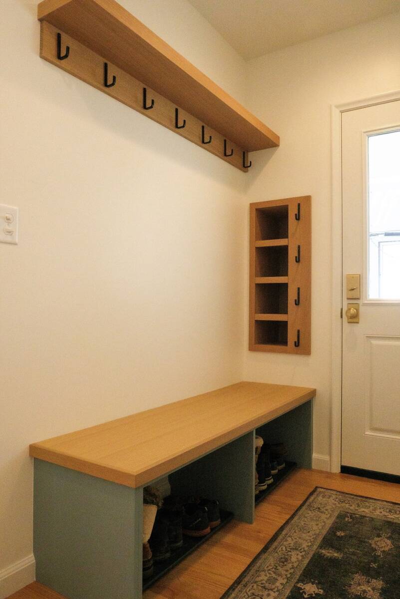 Small mudroom with a door to the exterior and cabinets.