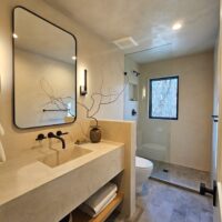 Thumbnail of http://Bathroom%20with%20open%20storage%20under%20the%20sink,%20a%20toilet,%20and%20a%20shower.