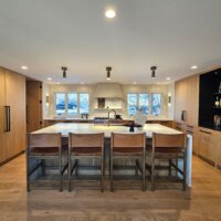 Thumbnail of http://Large%20kitchen%20with%20an%20island,%20range%20centered%20between%20the%20windows,%20bar,%20and%20hidden%20pantry.