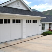 Thumbnail of http://Exterior%20of%20house%20after%20the%20remodel.%20The%20house%20is%20located%20with%20a%20view%20of%20the%20mountains%20and%20includes%20two%20garage%20doors,%20flowers%20in%20the%20landscaping,%20and%20white%20siding%20and%20windows.