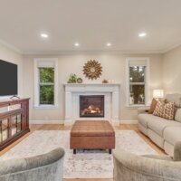 Thumbnail of http://Family%20room%20fireplace%20with%20windows%20on%20either%20side%20and%20seating%20in%20front.