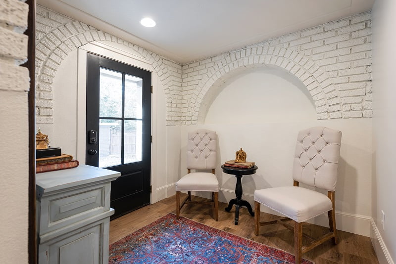Basement entry with white painted exposed brick