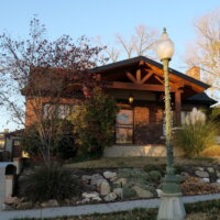 Thumbnail of http://Front%20exterior%20renovation%20at%20a%20brick%20house%20featuring%20a%20covered%20front%20porch%20and%20new%20landscaping.