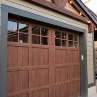 Thumbnail of http://One-car%20garage%20exterior%20with%20a%20concrete%20driveway%20and%20string%20lights%20hung%20above.