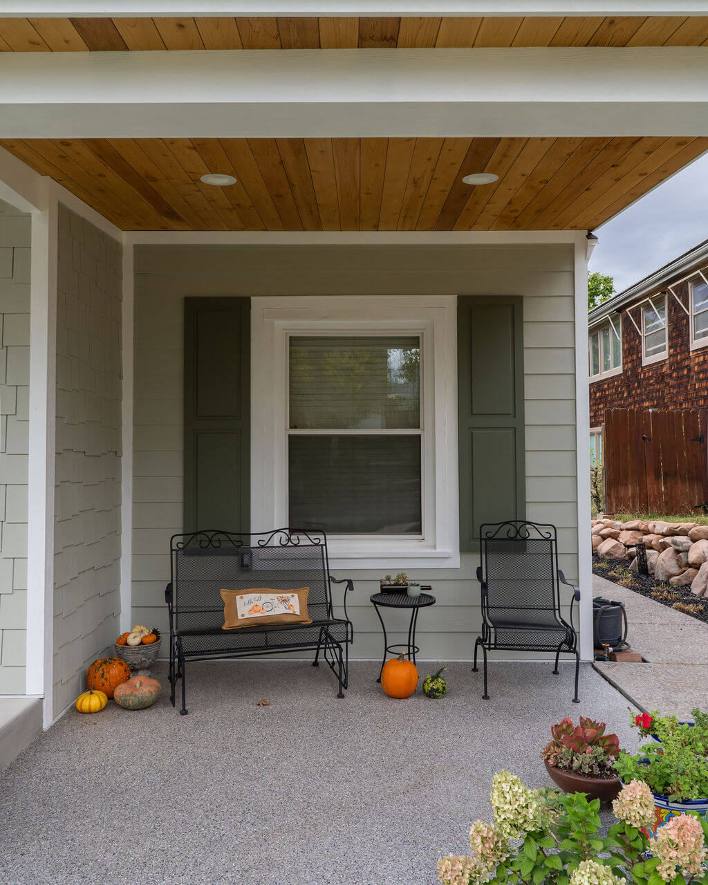 Front porch with fall decor and outdoor furniture.